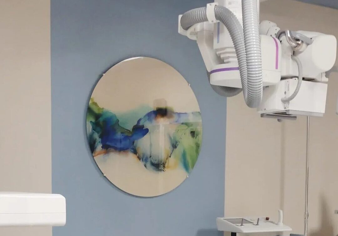A blue wall with a painting on the wall.